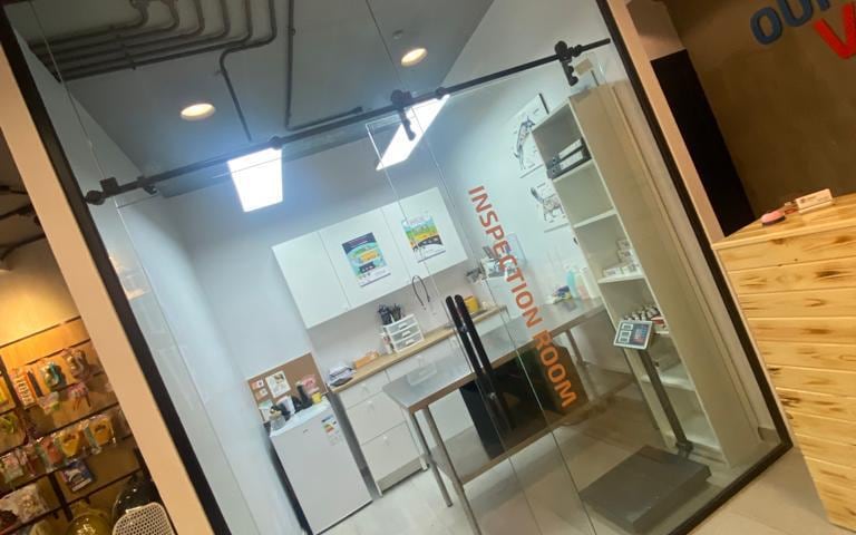 Petopia examination room seen through its glass partition